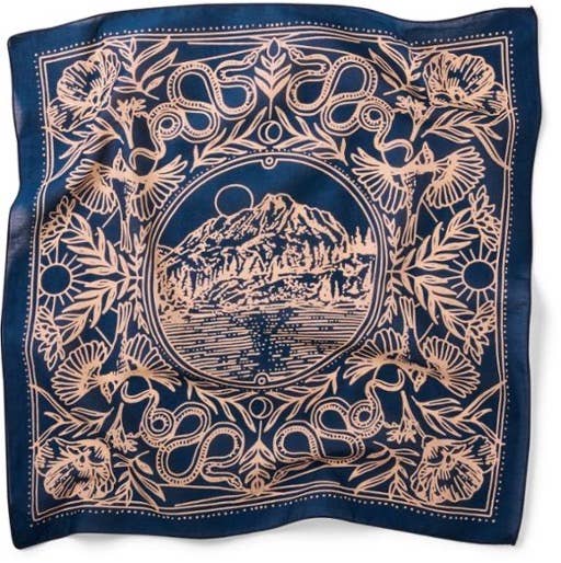 Dark blue with light pink colors depicting a mountain scene in a circle surounded by natural elements including flowers, birds, and rattlesnakes.